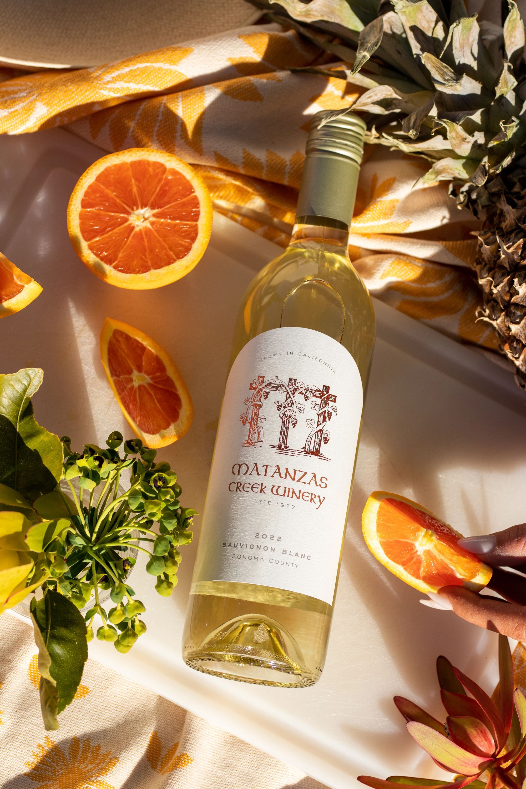 A bottle of Matanzas Creek wine with citrus and herbs